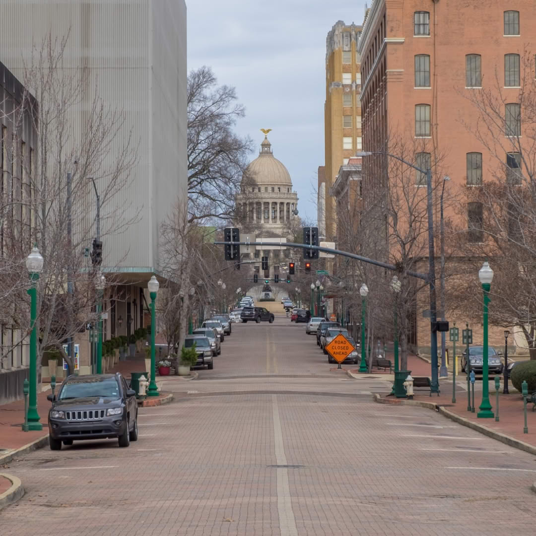 a Jackson, Mississippi, road with the capitol building in the distance